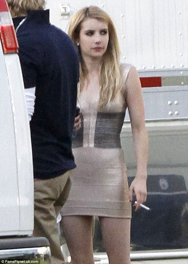 emma roberts relaxes with a cigarette while she chats with boyfriend evan peters